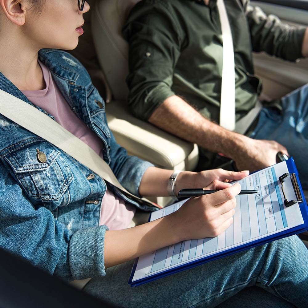 cropped-image-of-student-and-teacher-in-car-at-dri-FUHBPMU-min.jpg