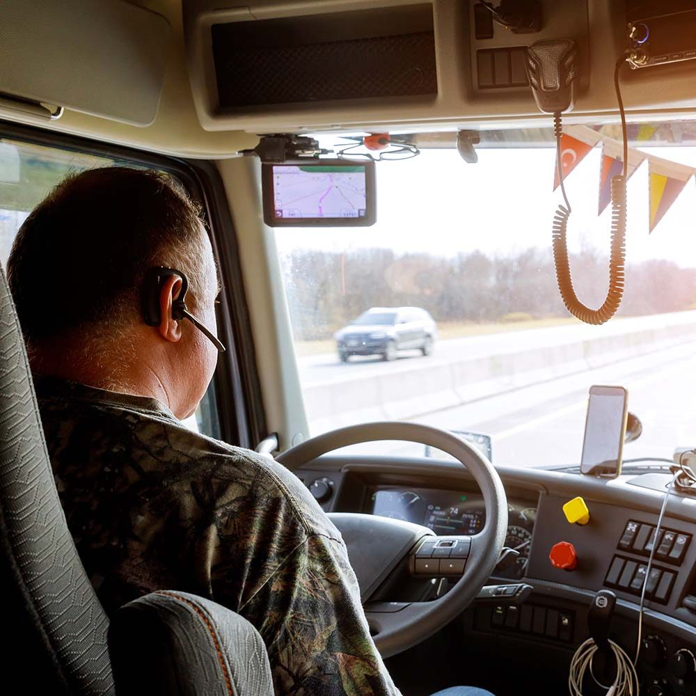 driver-in-cabin-of-big-modern-truck-vehicle-on-hig-5GCLPLG.jpg