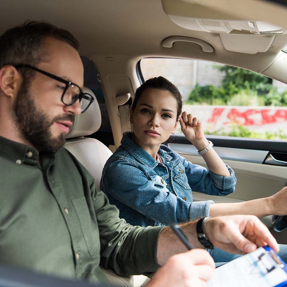 female-student-and-male-teacher-in-car-during-driv-8YMUJ7B.jpg